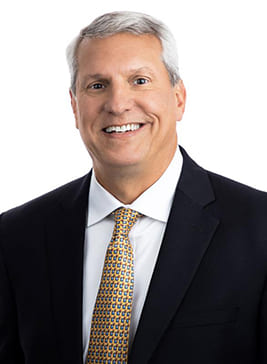 A photograph of Mark Henderson, President & CEO of PCI-PS